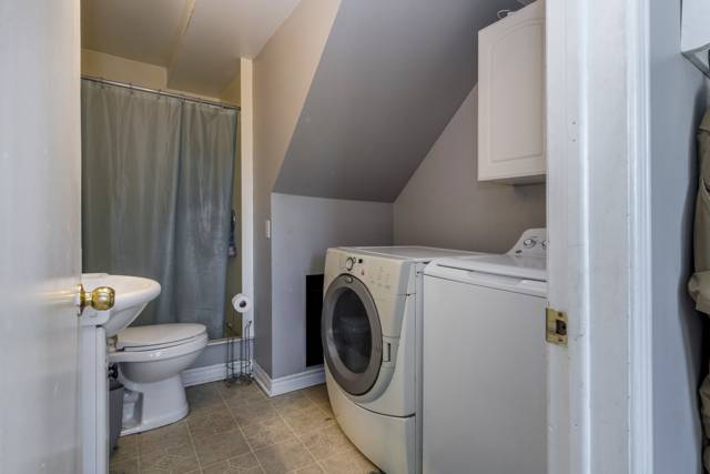 Main floor laundry: Front-load washer and dryer beside the bath