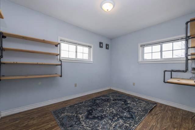 Bedroom 1: Two windows and built-in pipe shelving