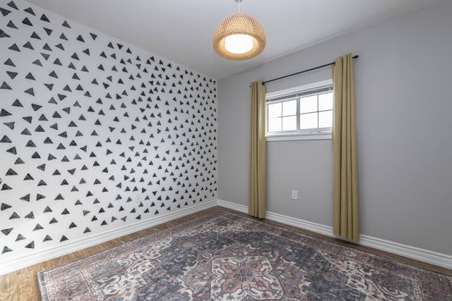 Bedroom 2: Feature wall and a bright window