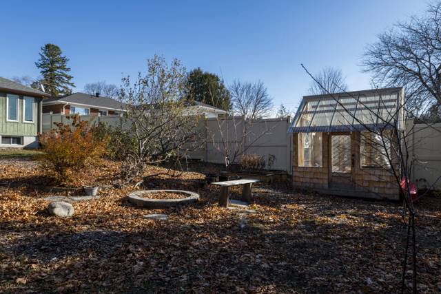 Greenhouse & back yard: Cedar-shake greenhouse and fire pit